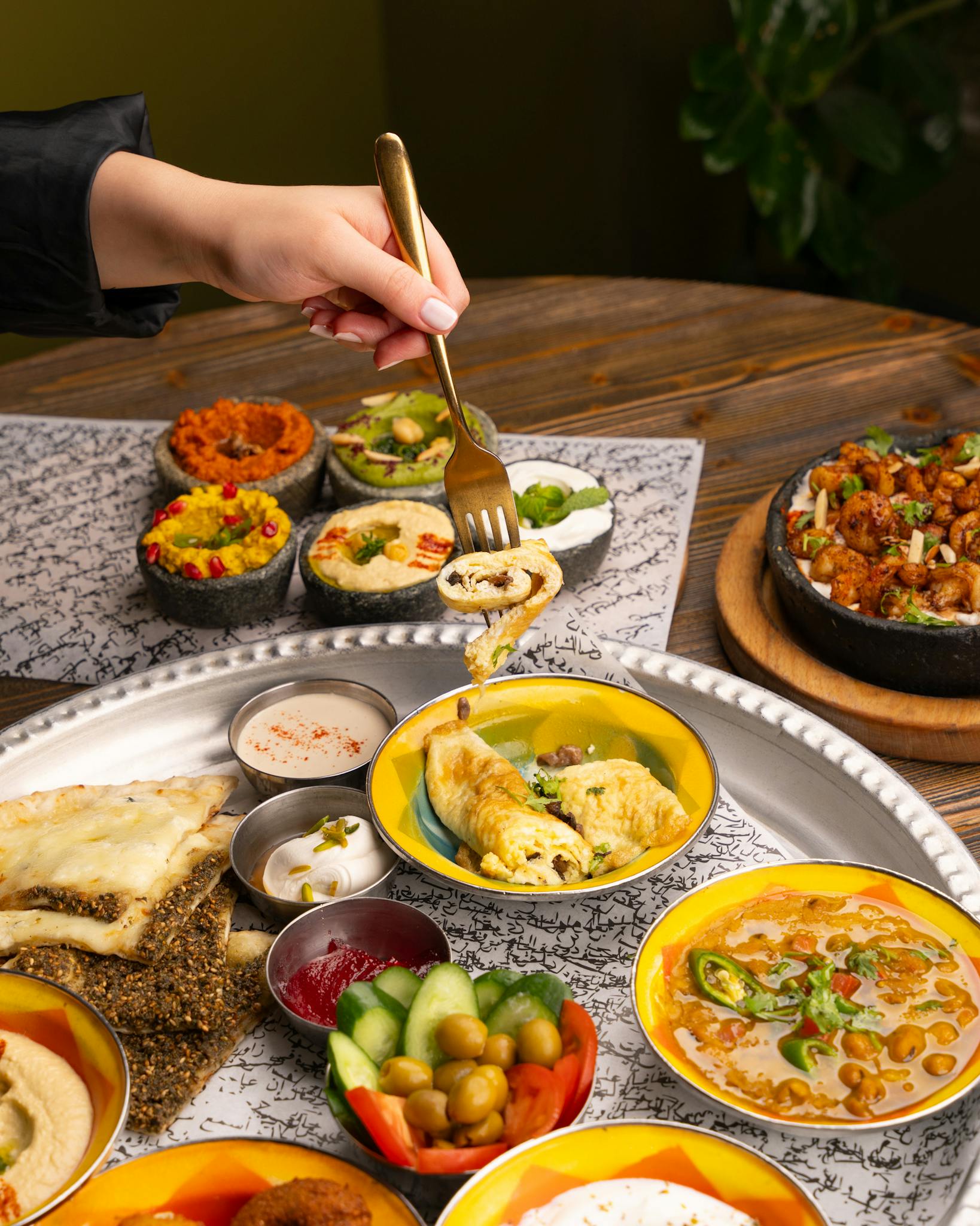 A vibrant assortment of Mediterranean dishes including hummus, salad, and pita bread. Perfect for culinary imagery.
