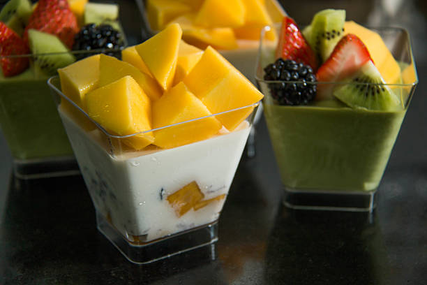 Delicious dessert with mango mousse in cup.